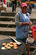 We bought some llapingachos, fried potato and cheese pancakes, from this friendly lady for 15 cents.