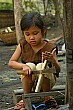 This little girl was carving handles for knives with very dextrous hands.