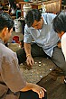 Watching men play checkers with bottle caps at the market in Vientiane.