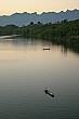 A few boats are left on the river at sunset.