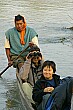 "Wow, that's a big nose you've got there!"  Raj tries out her binoculars from the dugout canoe.