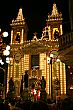 The brilliantly lit church with the statue of St. Leonard about to be brought inside.  Hundreds of people crowded into the town square, eating holiday nougat and watching the procession slowly make its way into the church.