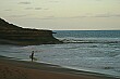 The crowds were gone and the sun was setting, but there were a few die-hard surfers in the water.