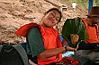 Our competent tour leader Raquel displays the banana-leaf-wrapped fried rice lunches we enjoyed on the boat.